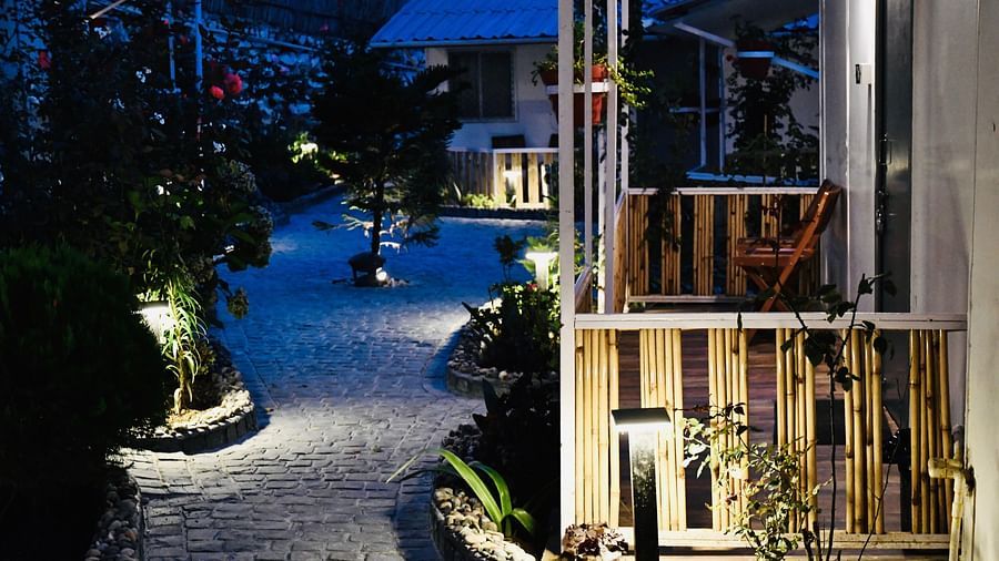 image of the exterior of the villas on a late evening with exterior lights switched on illuminating the stone pathways