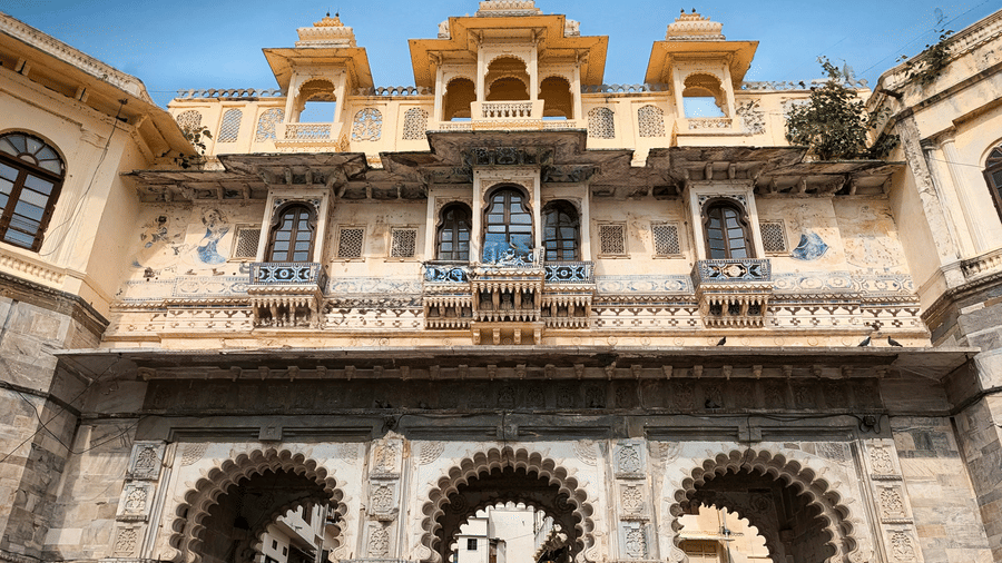 Ornate stone gateway with traditional Rajput architecture and intricate carvings at Ambrai Ghat, Udaipur.