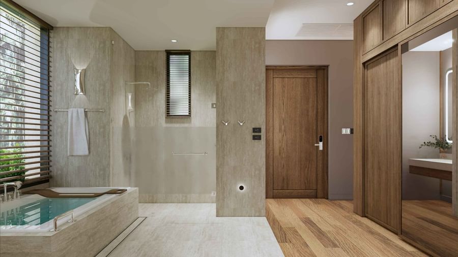 A bathroom with stone finish bathtub, separate shower area, wooden flooring, and mirrored wardrobe at Ramada Resort by Wyndham Khao Lak.