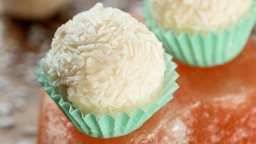 White sweets wrapped in teal plastic wrappers