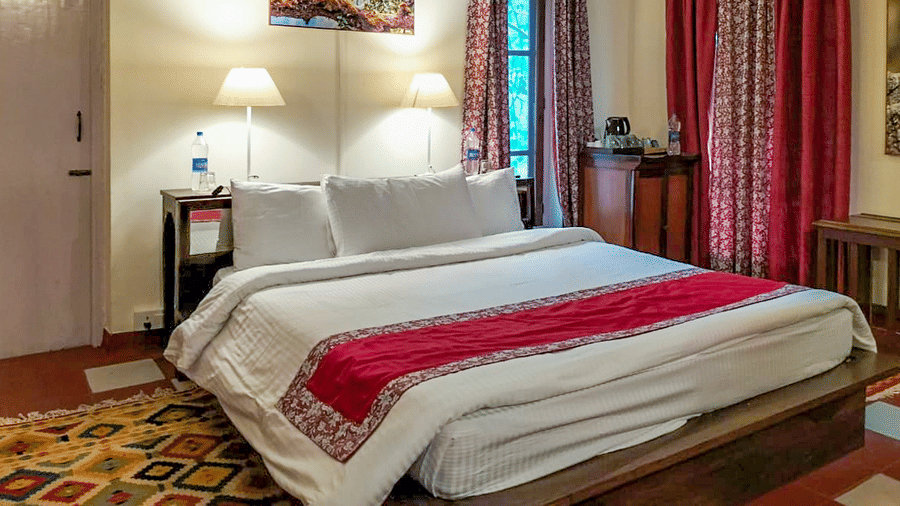 Contemporary bathroom showcasing a spacious glass shower area rainfall shower fittings and clean tiled surfaces at Neemrana’s Glasshouse on The Ganges ensuring a refreshing and private bathing space