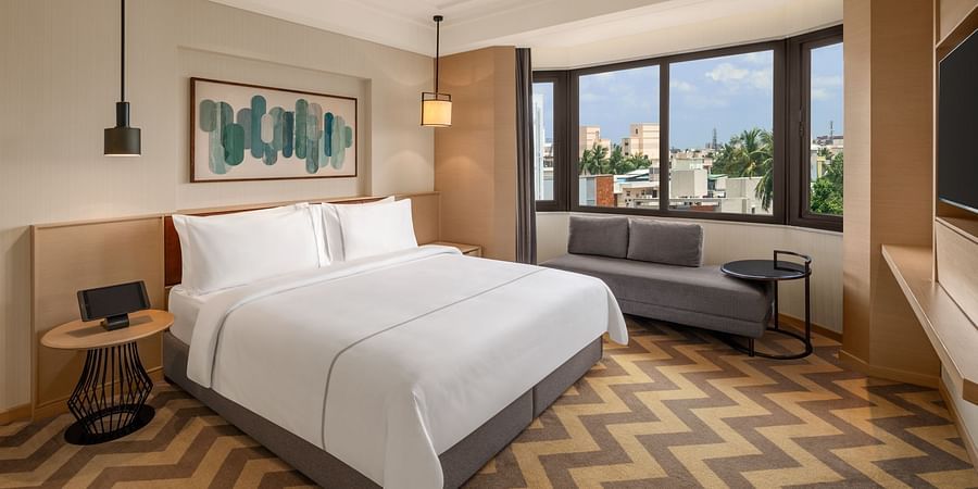 Suite room featuring a cozy bed and elegant bedside lamps at The Residency Chennai