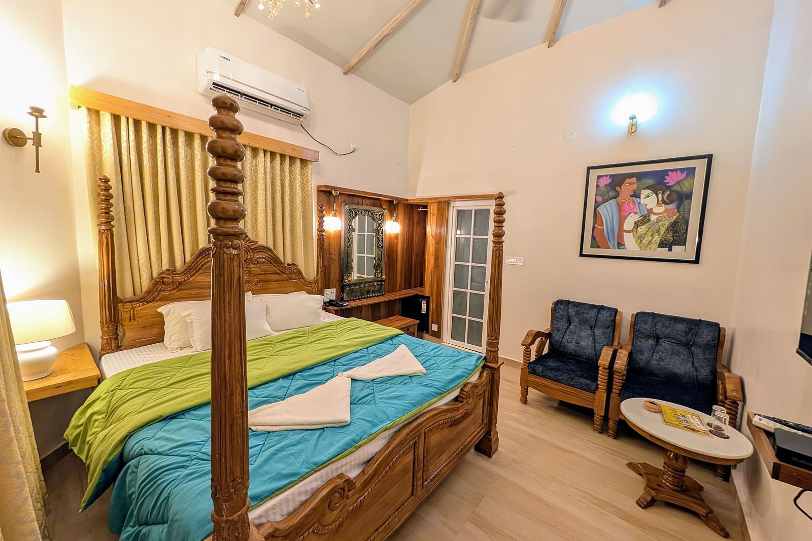 full view image of the pool side cottage featuring a double bed along with cushioned couch in the corner at dip holidays