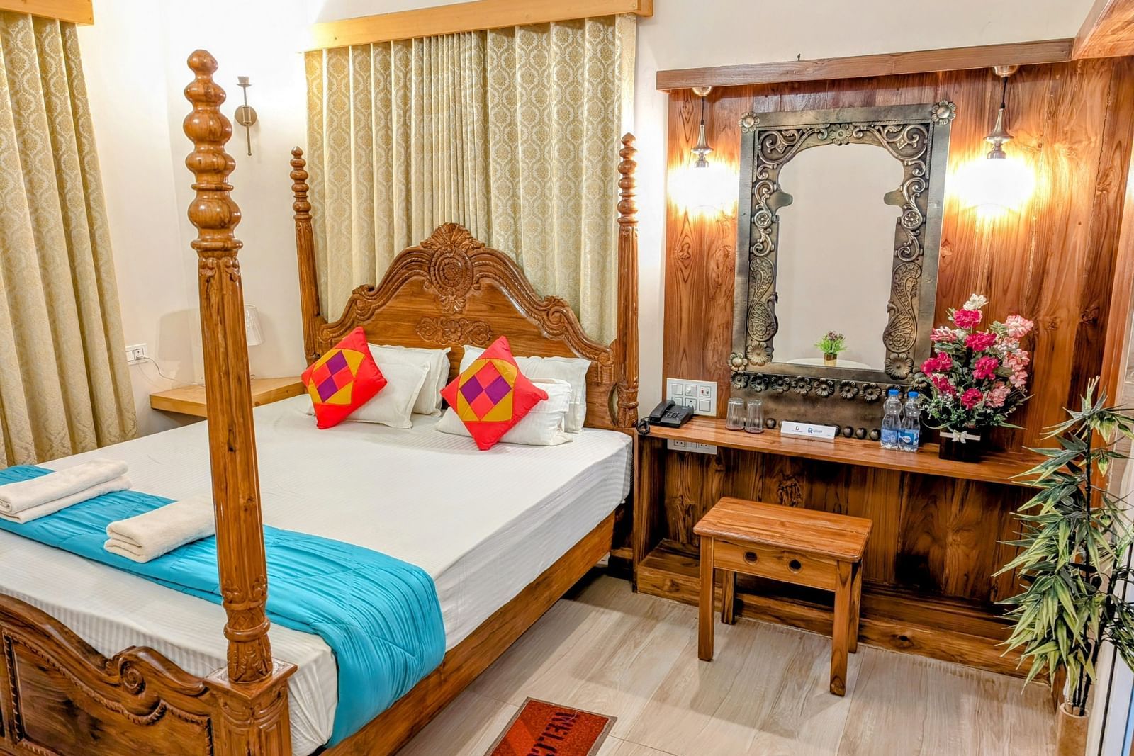 A double bed at the pool side cottage at dip holidays along with a dressing table besides it