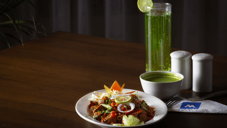 A beautifully plated gourmet dish served with a refreshing green beverage and a dip | Mount Lungta Boutique Hotel & Spa