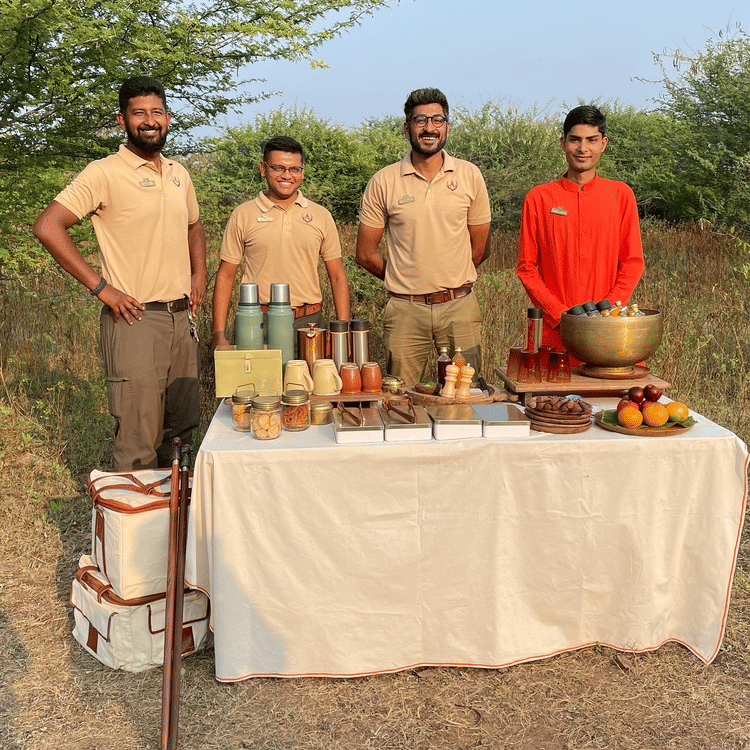 Visitors and staff smiling behind the table