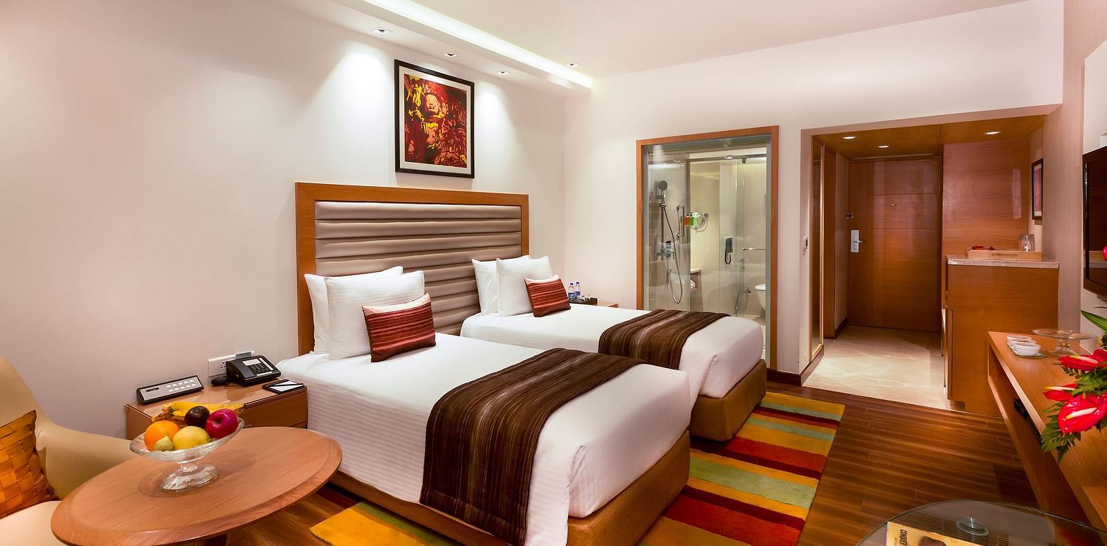 Business Class Room with a twin size beds and a TV at Grand Chennai By GRT Hotels.