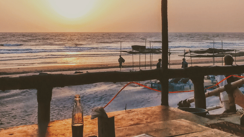 shack on a beach during a sunset