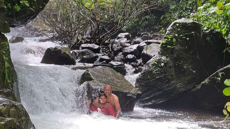 people enjoying a water stream near Holistic Stay Eco Resort, Kannur