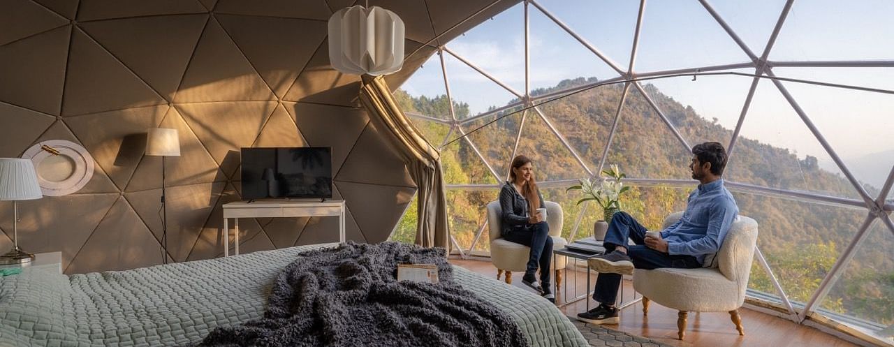 An image of couple having a chat in a room at avalon cottages view a serene view