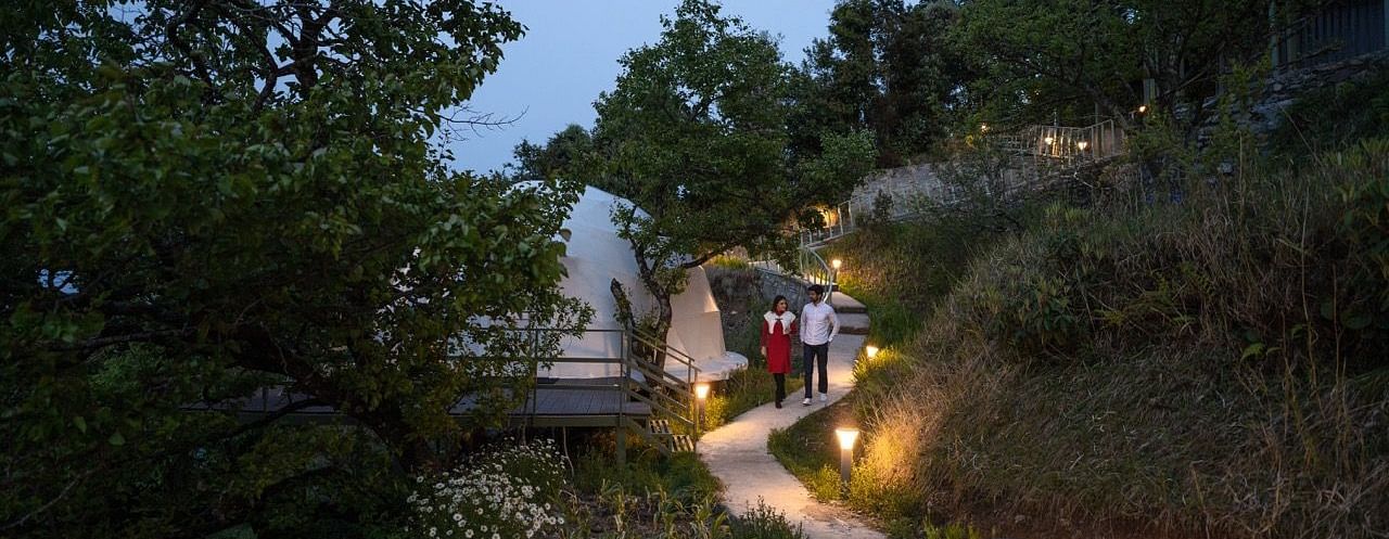 An image of a couple taking a stroll in the premises of avalon cottages