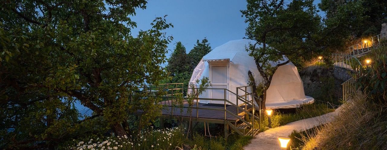 A facade of a dome cottage in the evening | Avalon Cottages, Kanatal