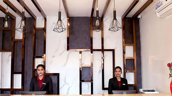 Receptionists standing at the desk at VITS Panchgani