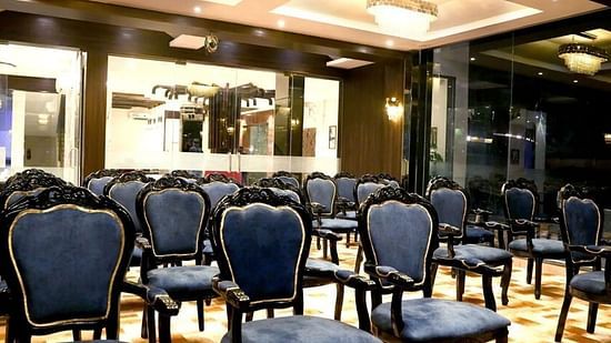 Seating arrangement using blue chairs in Topaz - the banquet hall at VITS Panchgani