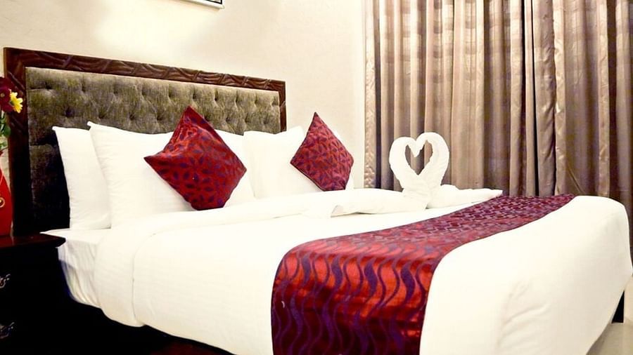 The Deluxe Room at VITS Panchgani with a double bed