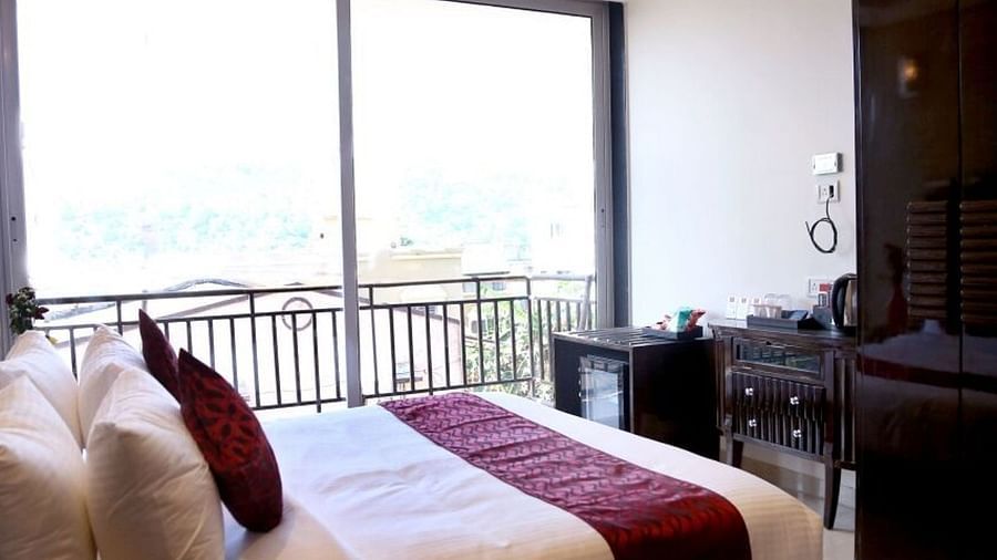 The Super Deluxe Room at VITS Panchgani with a double bed and a balcony