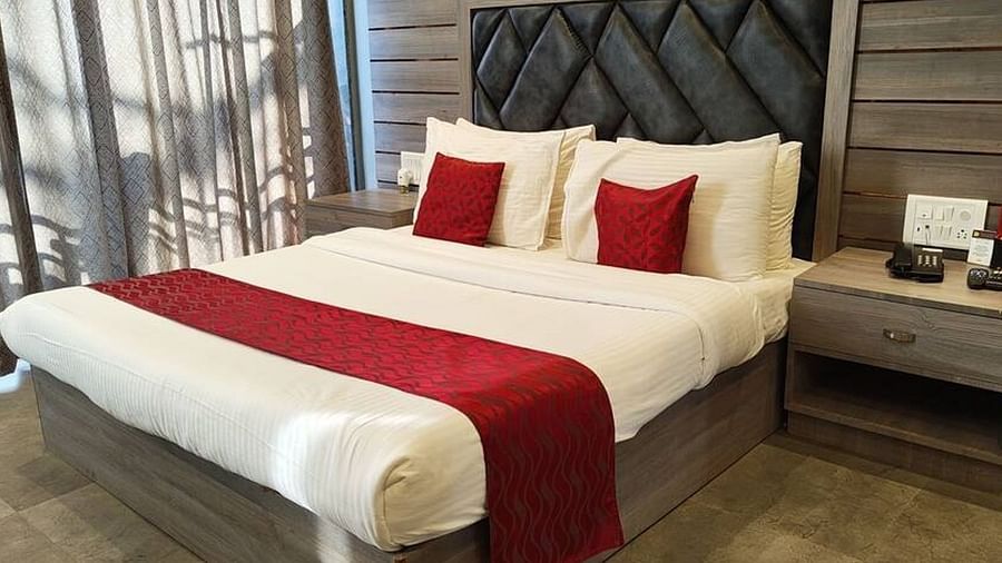 The Super Deluxe Room at VITS Panchgani with a double bed and a side table