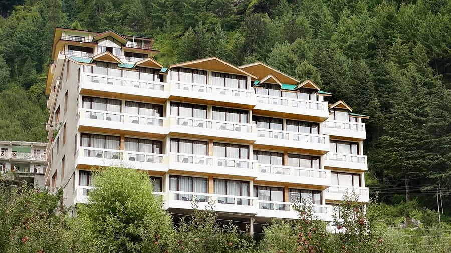A wide angle shot of the hotel with greenery around  | DLS Serenity Resort and Spa