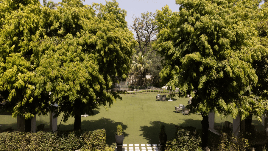 lush green view of the lawn from our lutyens luxury suite - The Claridges New Delhi