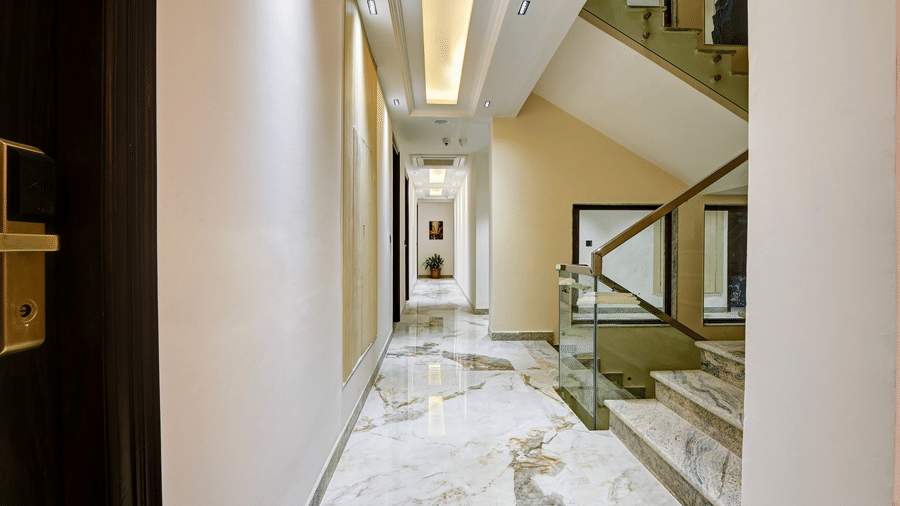 The corridor sharing several doors leading to their respective rooms along with a stairway in the side at Hotel 91 Privé, Gurugram.