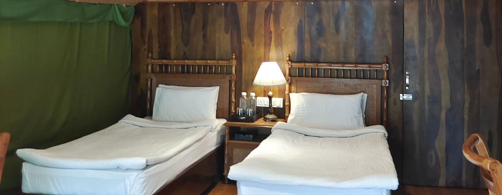 front view of a tent with two single beds and a single side lamp - The Jamoon, Corbett