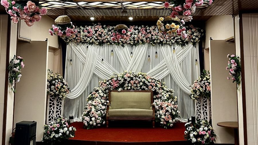 Floral ceiling decor with backdrop setup for wedding ceremony at Cedar Inn, Darjeeling, in an indoor event space.