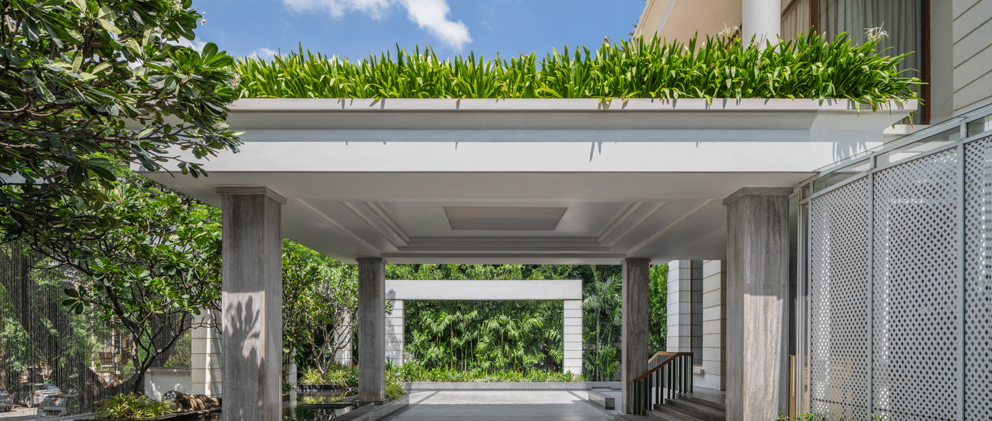 Covered driveway with plants and hotel entrance at The Raintree, St. Mary’s Road.