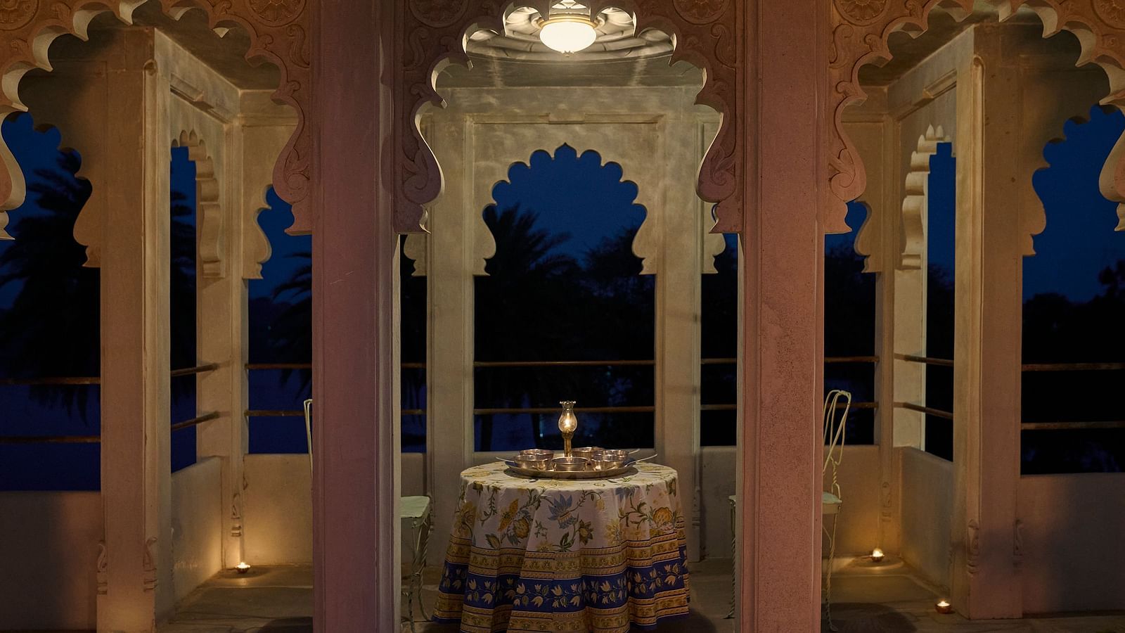 image of a balcony with arched pillars featuring a round table in the middle at Dev Shree, Deogarh