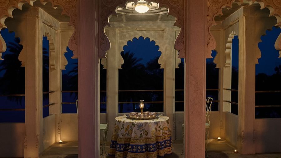 image of a balcony with arched pillars featuring a round table in the middle at Dev Shree, Deogarh