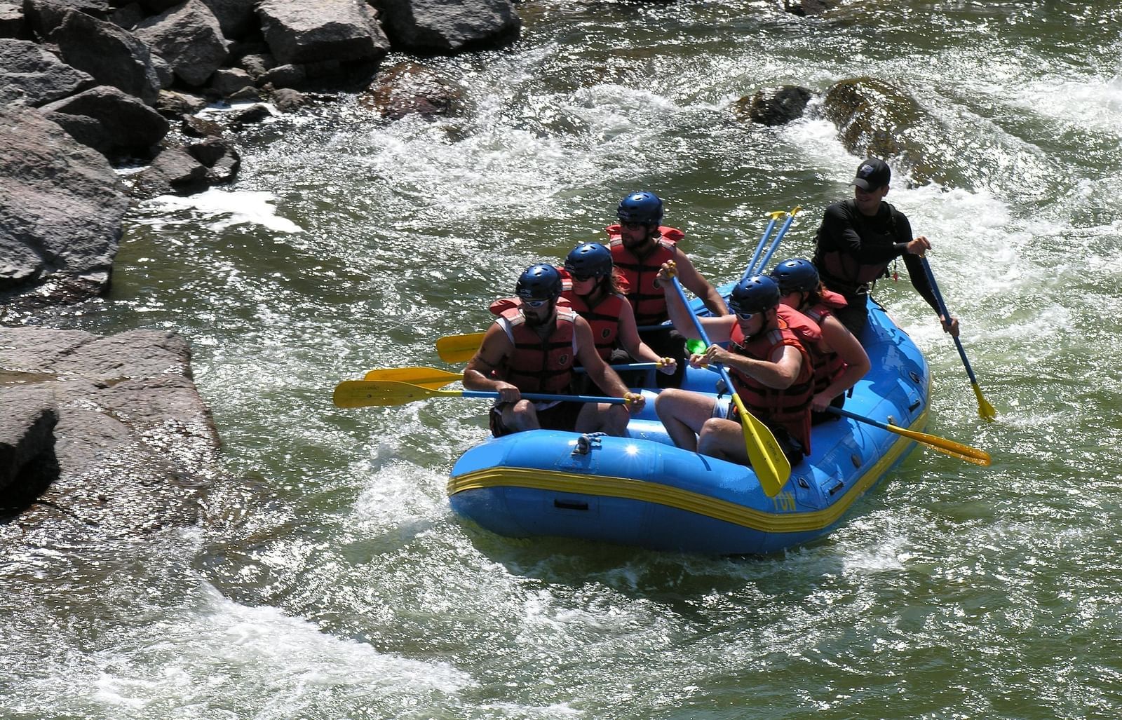 An image of a group of people rafting on a river