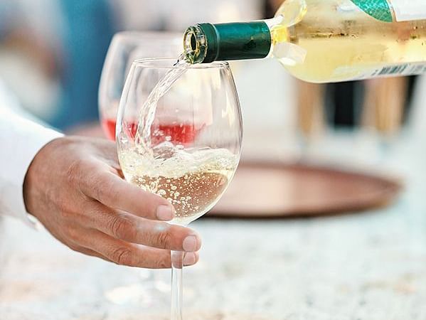 A glass of champagne being poured into a glass - S Hotel Kingston, Jamaica