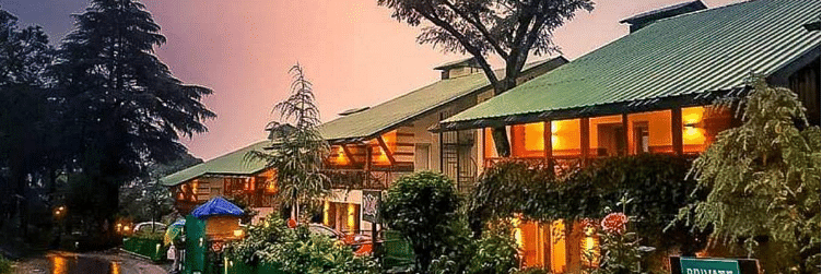 An enchanting exterior of our hotel decorated with aesthetic yellow lights and captured during sunset - Lamrin Norwood Green, Palampur2