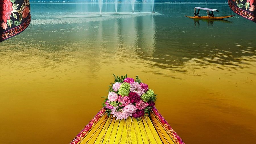 A bouquet is placed at the edge of the boat. At at distance there are other boats moving on the lake.