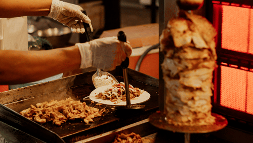 image showcasing chicken being roasted for preparing Afghani shawarma