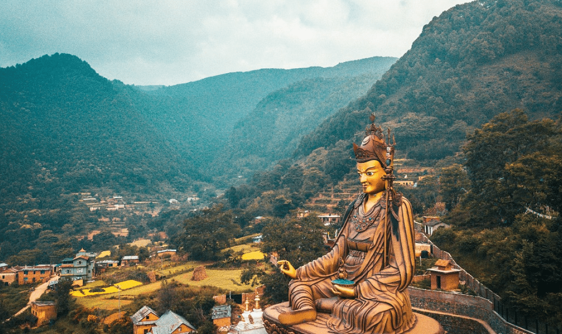 A huge statue of a religious idol surrounded by a few temples | Kavya Resort and Spa, Nagarkot