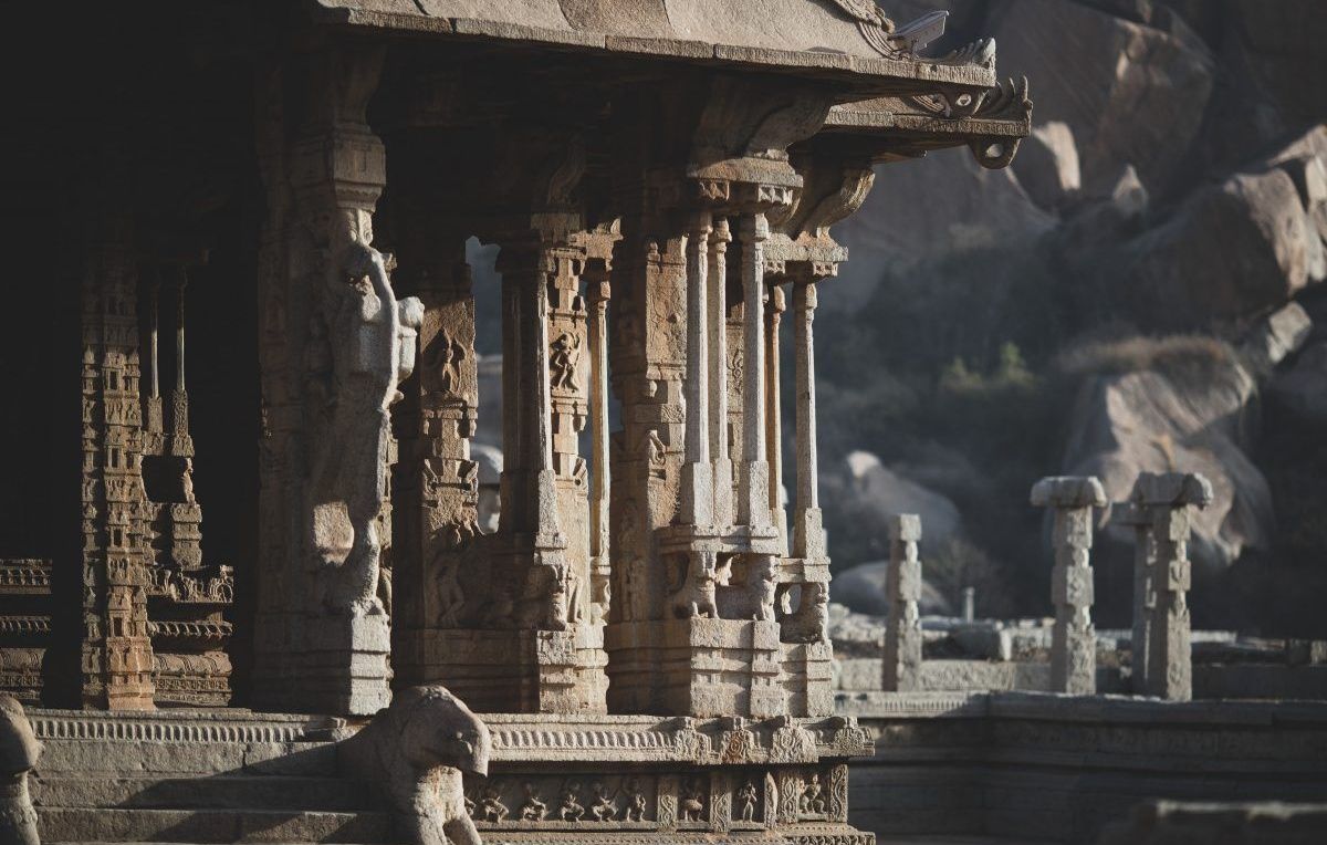 Ancient temple ruins with intricate pillars in Hampi.