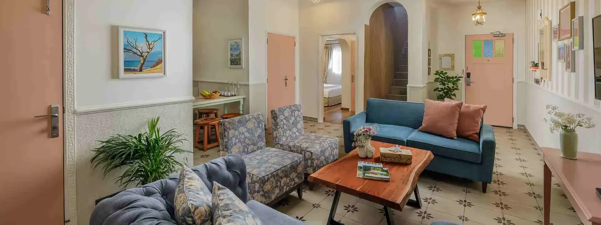 Indoor lounge with armchairs, sofas, and wall art at Karma Chalets.