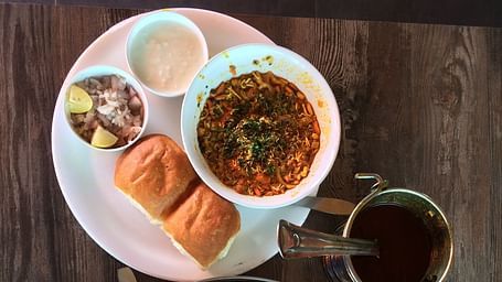 Aerial view of Maharashtrian dishes kept on plates on top of a table.