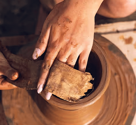 A  hand doing pottery at Avana Resort