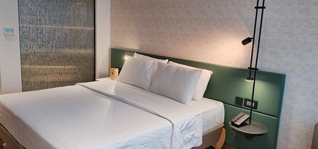 A king size bed in the Deluxe Room at Regency Hotel, Mumbai.