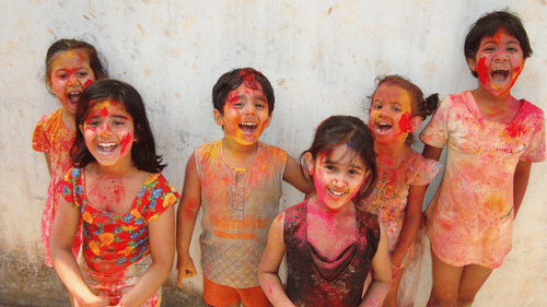 Kids playing with colours on holi