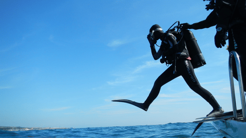 A man about to jump into water with costume and safety gear