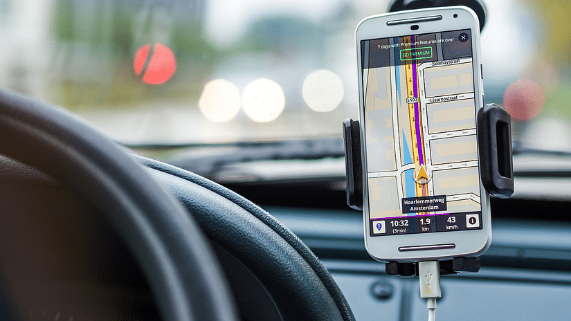 A mobile phone showing navigation in a car