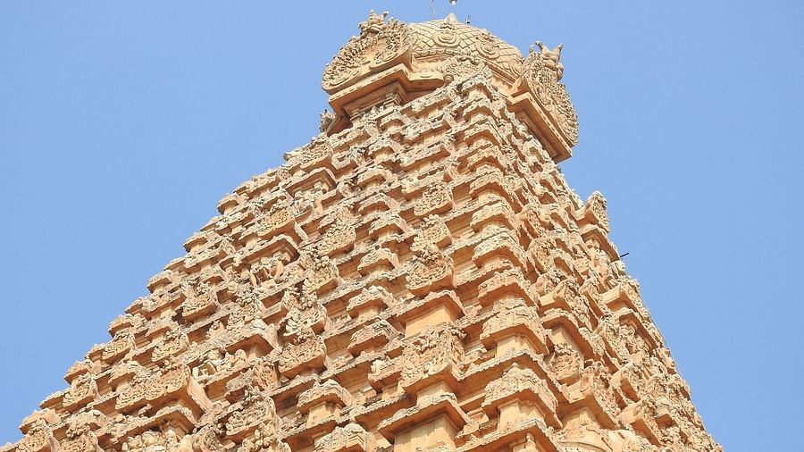 Temple in Tamil Nadu with a towering gopuram and carvings on it.
