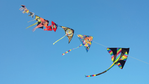 Row of kites flying in the sky