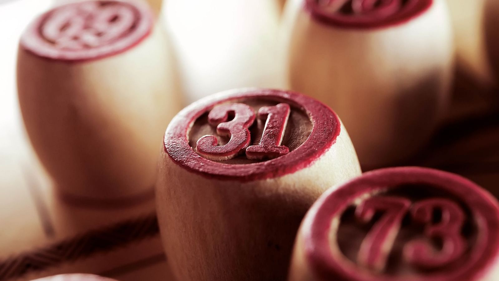 A close up shot of wooden pieces with numbers on them that are used for Tambola at Rhythm Lonavala.