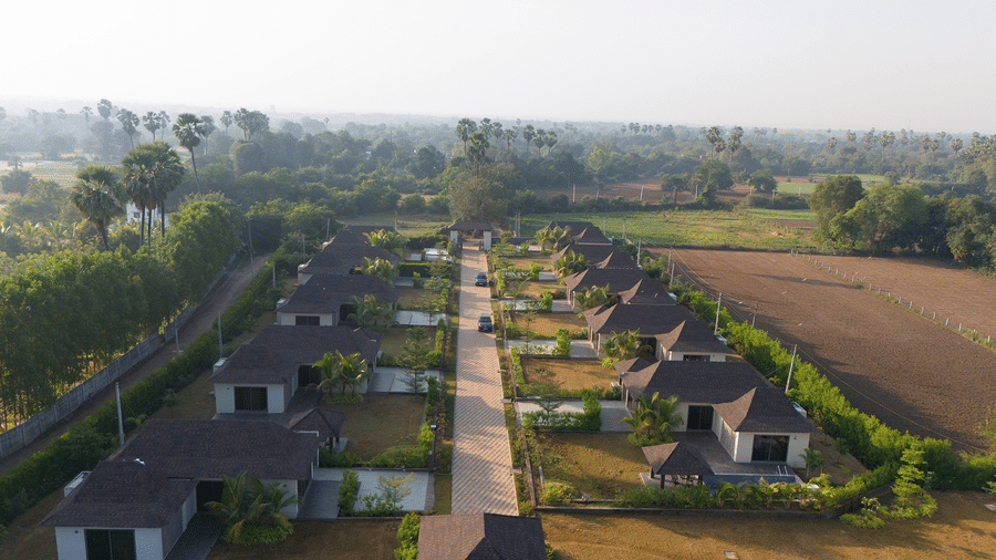 A high-angle drone shot showing the organised layout of guest villas and green landscape - Daksh The Nirvana Retreat, Pavagadh