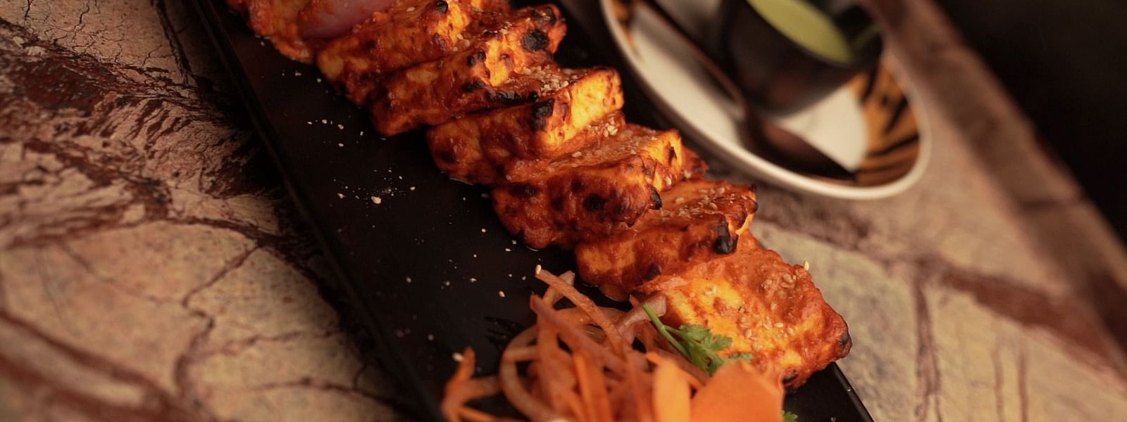 An image of a paneer tikka served in a platter - Pai Group of Hotels