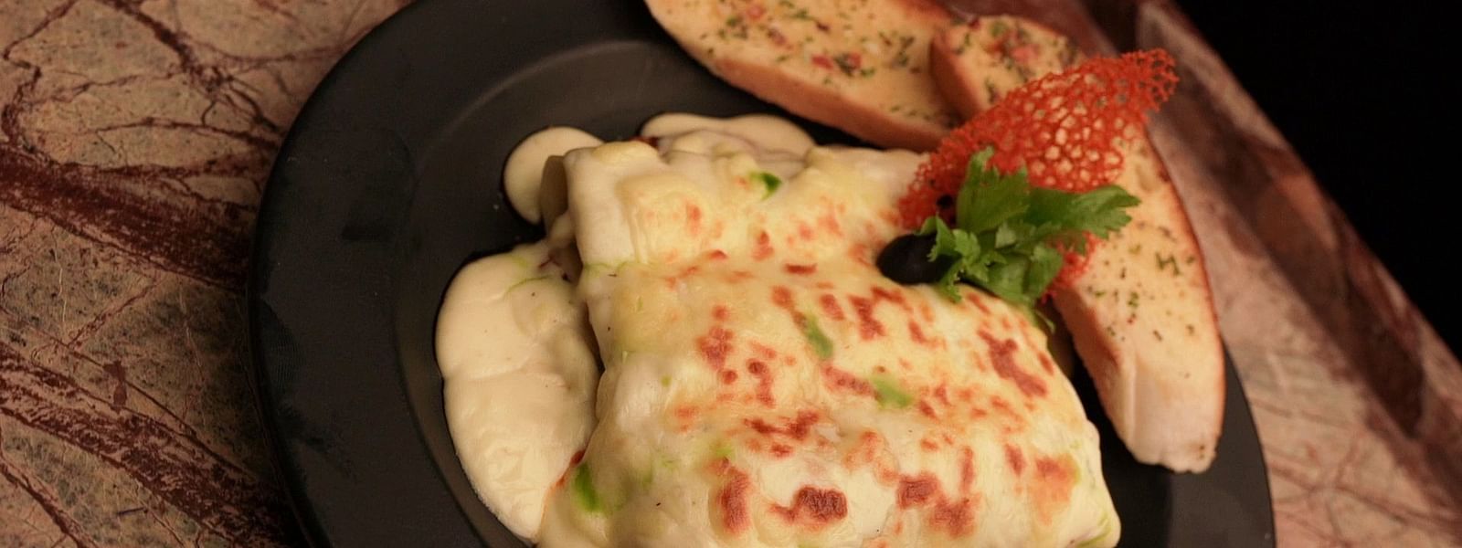 An image of dish served on a table - Pai Group of Hotels