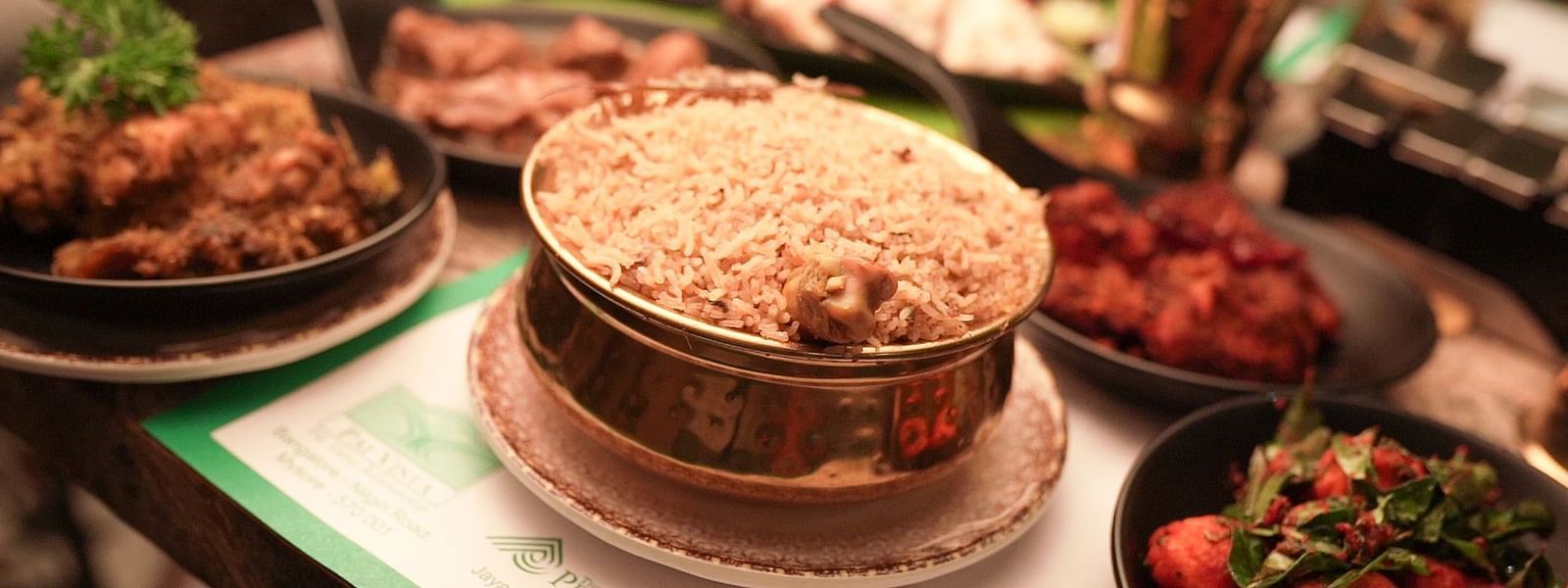 An image of chicken biryani with chiecken gravy and fry - Pai Group of Hotels
